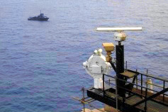 View of ocean vessel and waterside security equipment from harbor
